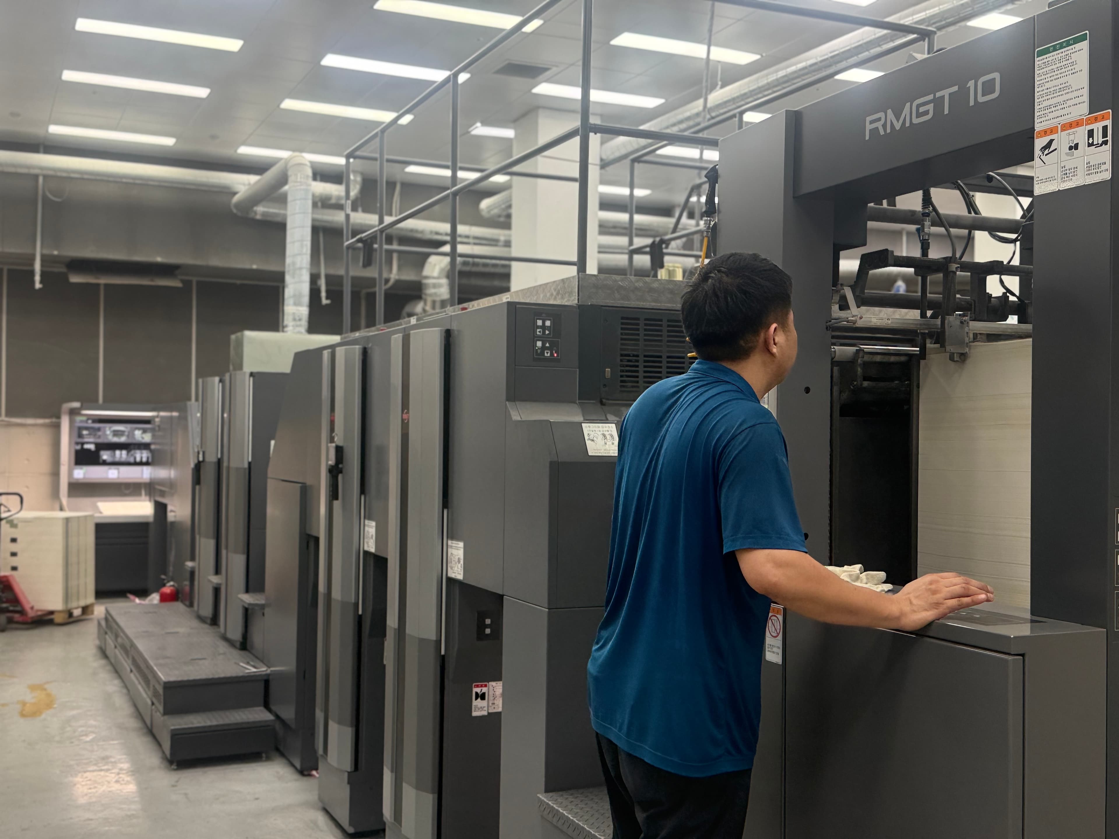 Production staff operating a large-format offset press